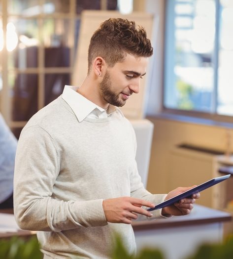 SamsaTech Man looking at Tablet